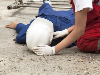 injured-construction-worker-lying-on-his-back-and-receiving-care-1.jpg