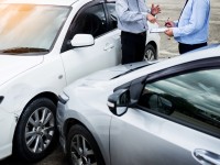 insurance-agent-writing-clipboard-while-examining-car-after-accident-scaled-1.jpg